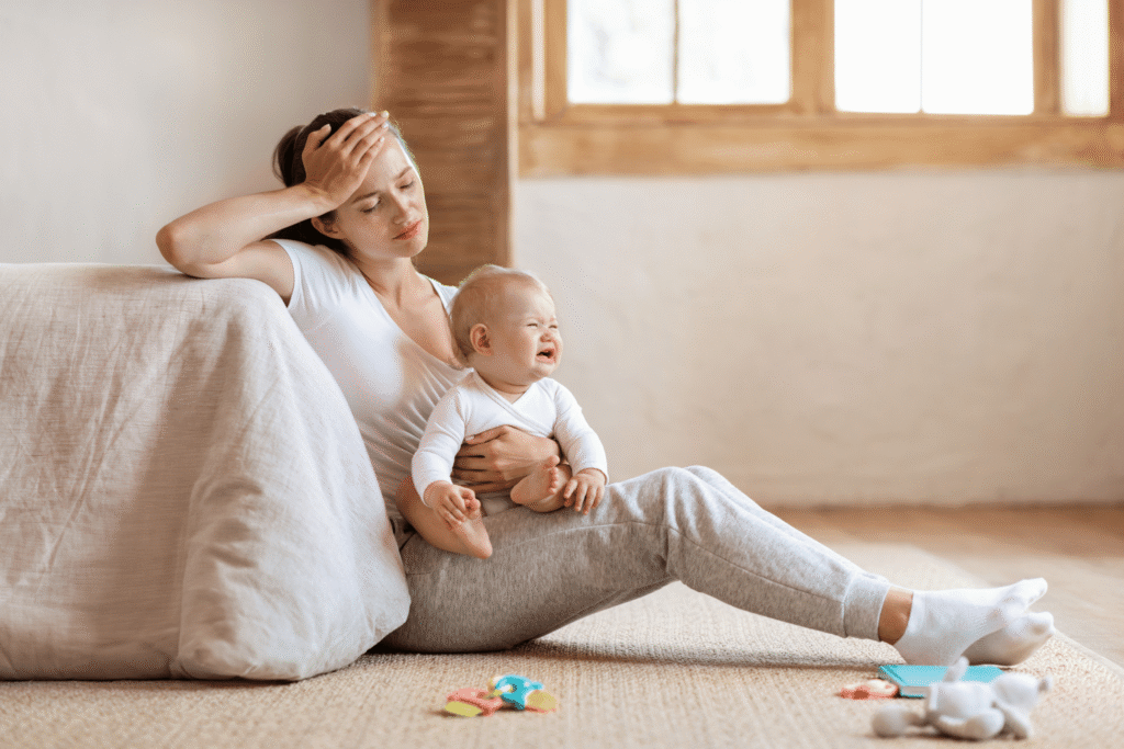 Exhausted parent holding baby